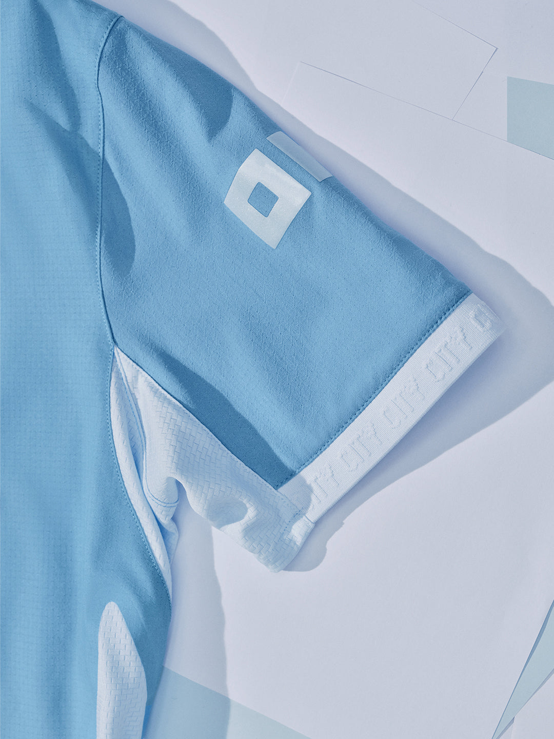 Light blue sports jersey with a logo on a white background