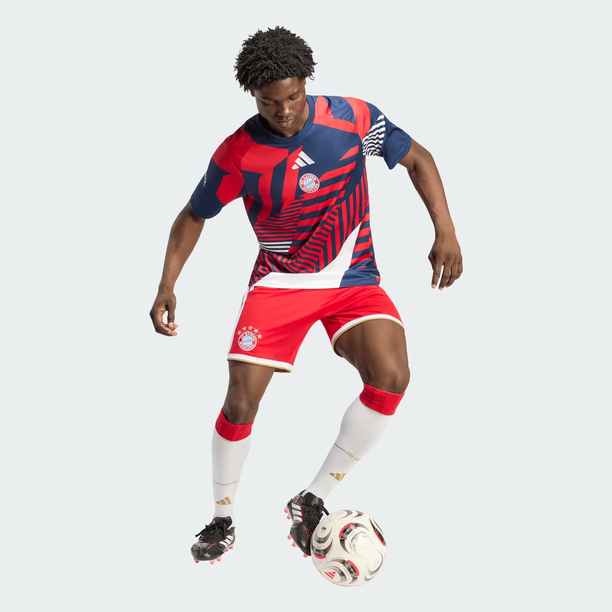 Person wearing a red and blue sports outfit with a soccer ball on a white background